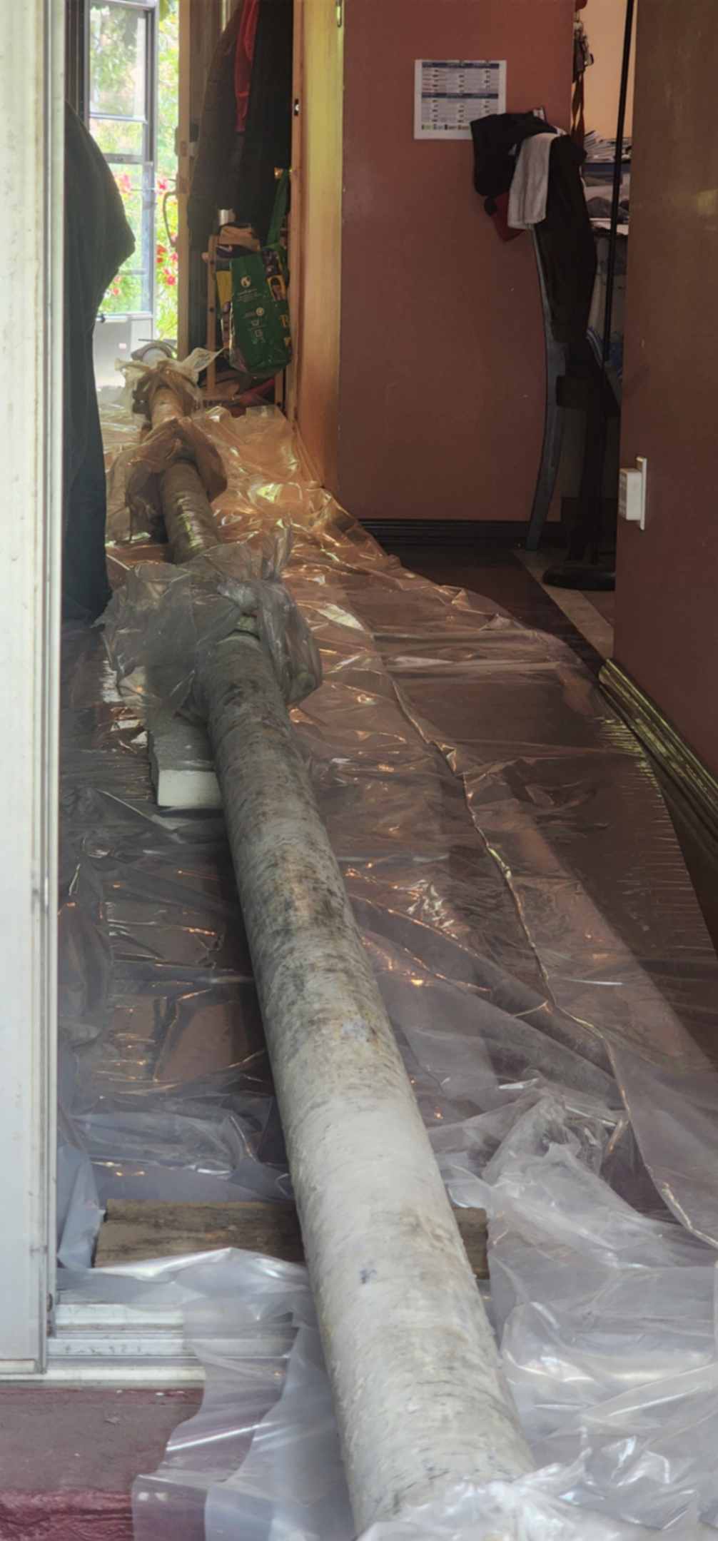 Concrete pumping line routed through a Toronto house to a hard-access backyard placement.