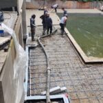 Concrete pump truck placing concrete on a construction site in Toronto GTA