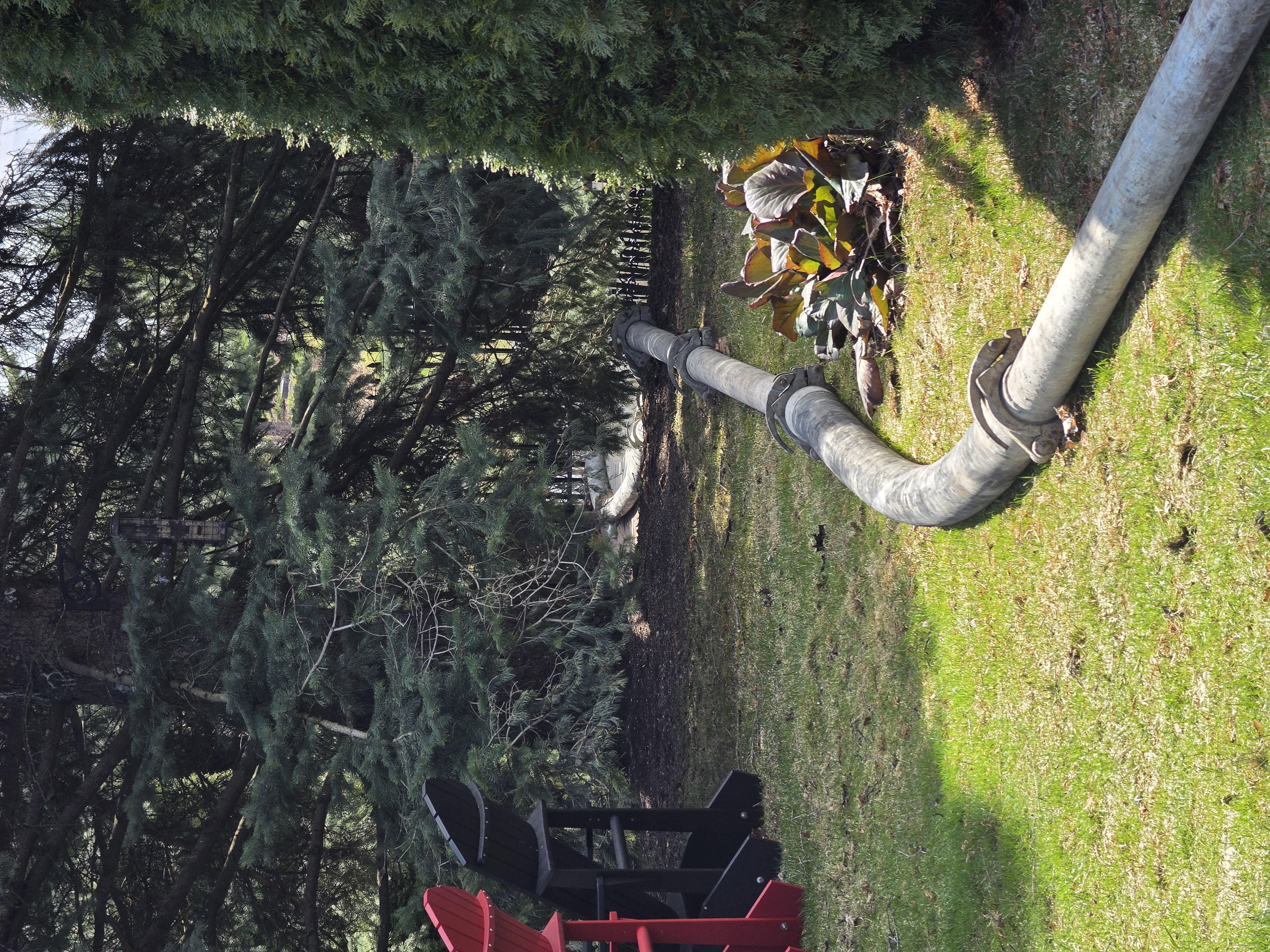 Concrete pump pipe and hose routed across a property for a long-distance concrete placement.