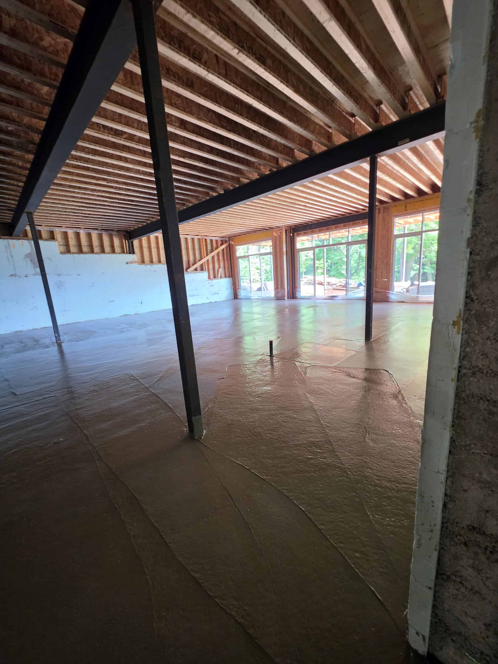 Concrete pumping for a basement slab with controlled hose placement.