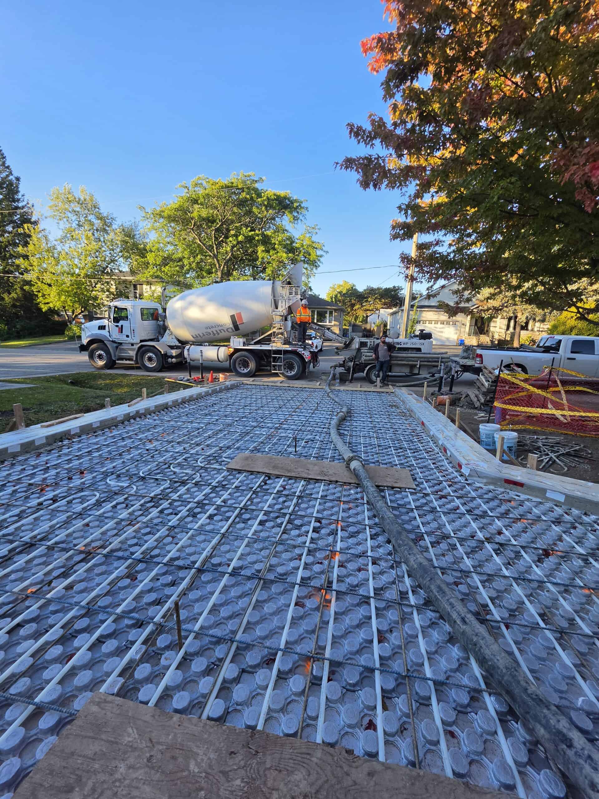 Concrete line pump hose laid across a reinforced slab before a concrete pour.